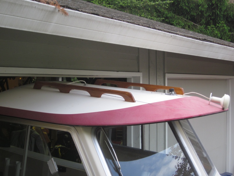 Barely fits into 6'11" high garage door on a EZ Loader 14-18 2100 Roller trailer, but had to remove antennas from roof. Later remounted them elsewhere.