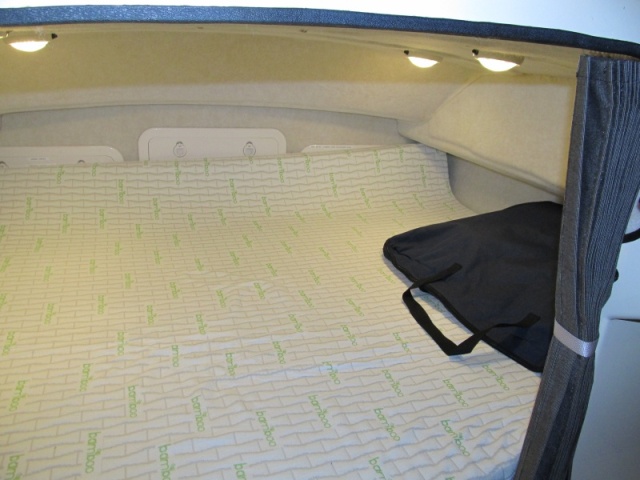 berth with topper from amazon.com.  Marinebeam 18-LED lights.  Cabin 9 white, 3 red LED provide what E calls "that New Amsterdam Bordello effect" for when you want that.