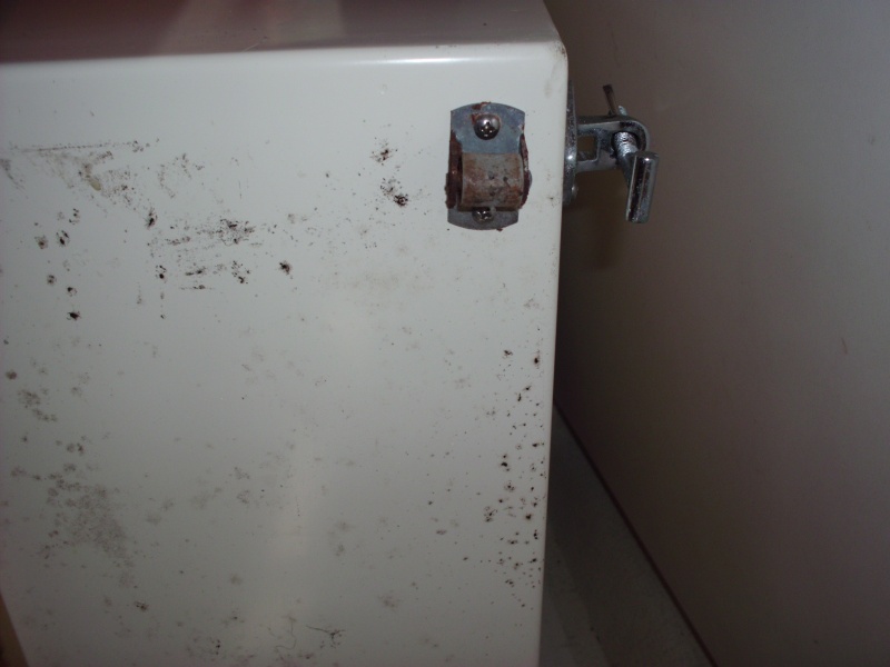 Bottom of chair shows roller caster and side bolt to attach to floor