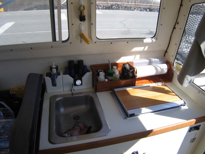 Built Galley Storage Out of African Mahogany and finished with Spar Varnish. Pooped out on building the rest of it and just bought some plastic stuff from West Marine.  Works well, just doesn't look as good.