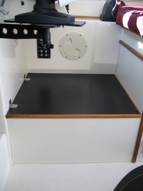 By raising the helm it gave me room to install a 12-inch high storage compartment as a foot rest.
