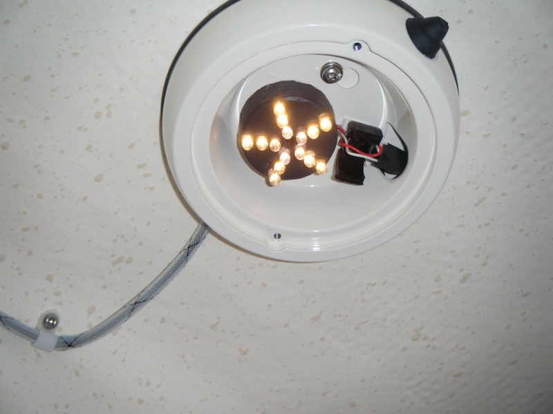Cabin light lens off.  LED draws .009 amps.  Clip off old socket and solder to existing leads. Light mounts to factory frame with marine adhesive. (11MAR10)