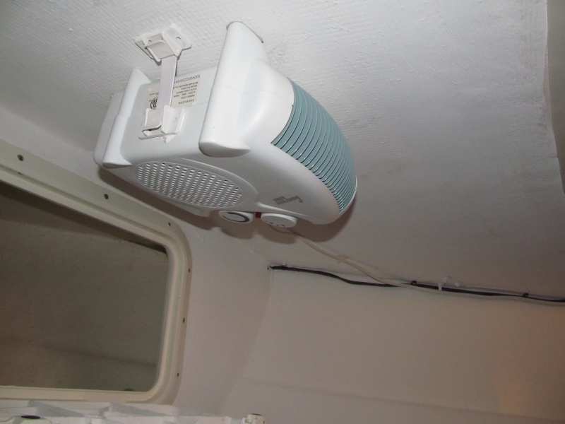 Ceiling heater second view.  Its a table top model and I hung it with 5200 and RV appliance straps.  Solid for 1.5 years now.