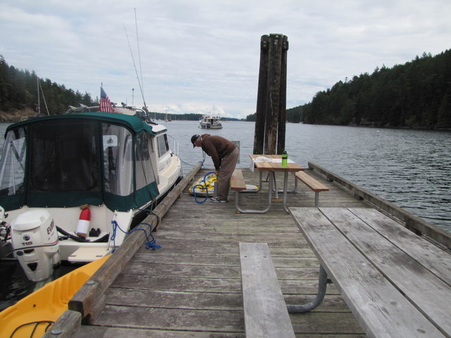 Charlie pumping up kayak on floating dock.