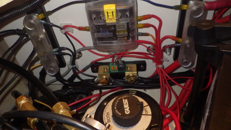 Cleaned up wiring in starboard lazerette.  Battery on left. Autopilot pump on right.  Buss bars and fuse box instead of spaghetti.