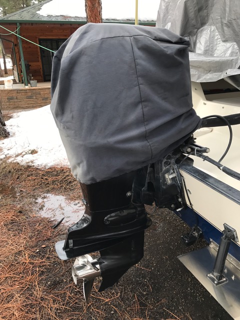 Covered Suzuki DF 90 outboard engine.
