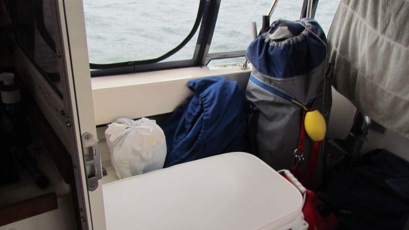 cruising cockpit complete with dink and motor (behind the towel) trash to go ashore,laundry bag