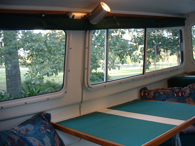 Curtains held up by nylon straps and snaps.