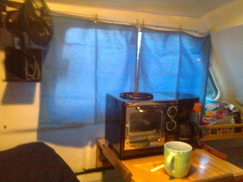 Curtains made out of $3 cloth napkins from Walmart, $2 cafe rings, $2 tension curtain rod.  They color match with the rest of the upholstery is perfect.