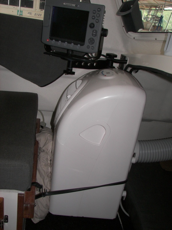 Cushioned with pillow, bungied to seat rail and E-80 bracket. Ground fault interrupter came built-in. 965 Watts,8.5 amps running, 15.3 amps start, delayed rotary compressor.