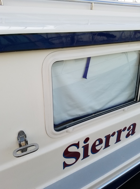 Dana\'s new step up top, a SS folding mast step.
Also one of Dana's co-workers did a marine grade professional coating on the dark blue brow and overhang, I polished it out a couple of months ago with my normal marine products and it didn't get shine and color like this!