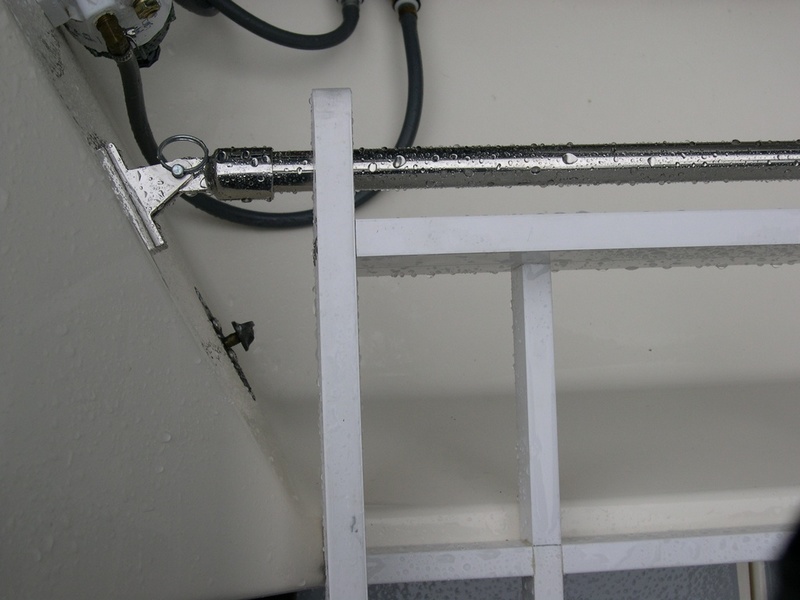 Detail showing 7/8" stainless railing, fittings and connection to motor well.  Rack pivots up for access to well.
