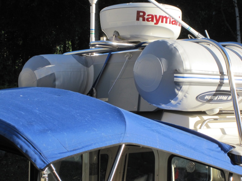 Dinghy is actually hung from the radar arch using a ratchet strap that hooks onto the transom. Front is tied down to roof rails.