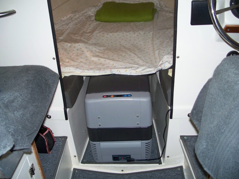 Dometic CF-50 fits easily in V berth with filler cushion removed. Height almost same as bunk height and refrig will support our weight as we enter/depart berth. We have never used this area for the head. It is kept on deck during day and placed just inside cabin door at night.