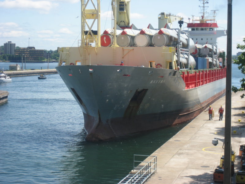 Dutch ocean going freighter carrying wind generators entering lock.