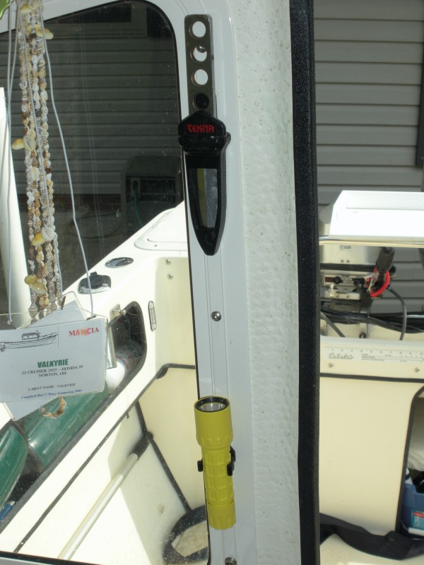 Emergency gear added near the door for quick access.  Surefire LED flashlight is mounted in 1&quot; clips available from West Marine.  Tekna dive knife mounted above the light.  Both use screw holes in the window frame for mounting.