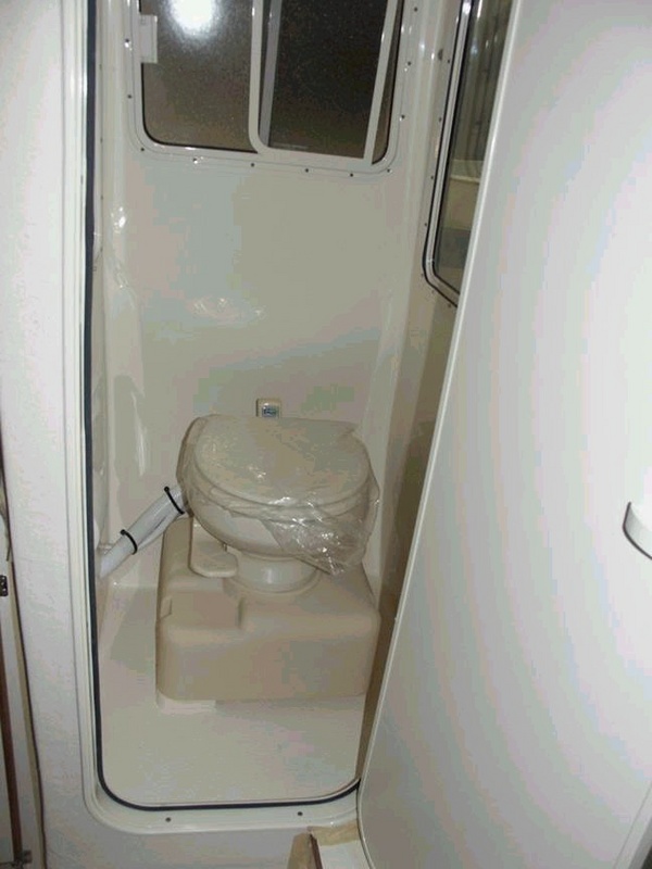Finished Sealand head. Advantages: frees up deck for fish box; no more fittings below the waterline; uses fresh water (minimal oders easy to clean); step on pedal to flush (Helen approves); all plumbing is easy to repair.  Disadvantage: uses fresh water supply. 3/15/04