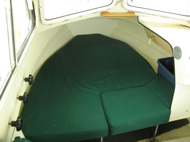 Foam cut back to provide bin storage under dash. Teak handle angled and glued to assist entry & exit from berth