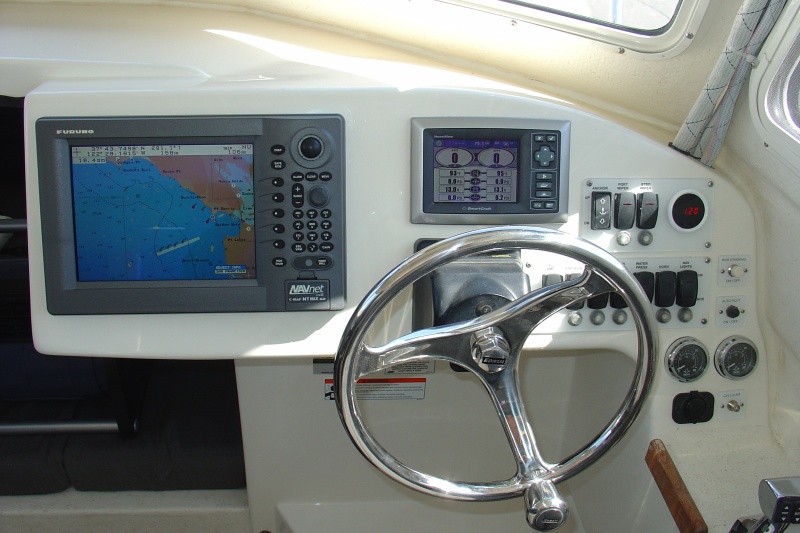 Furuno Navnet Radar-Plotter-Fishfinder and Mercury Vessel View Display.  Also added stainless Edson Wheel with Power Knob.