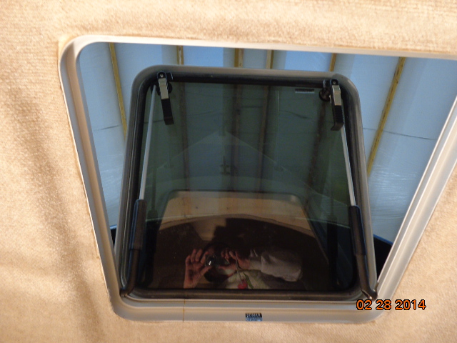 Getting the hull liner fitted around the hatch in the V-berth.