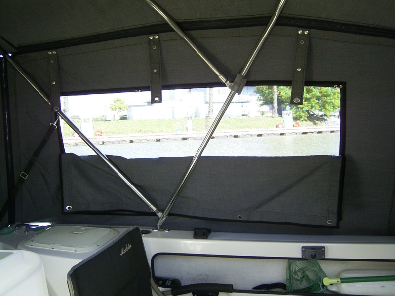 Half screen with the solid panel snapped in the middle. The straps at the top hold the whole side panel when it is rolled up.