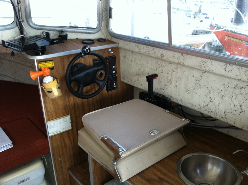 Helm with seat folded; manual sink. Port-a-potti is visible in lower left corner of the photo.