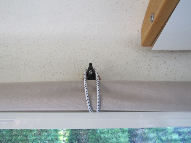 Hook to hold window curtains when not in use.