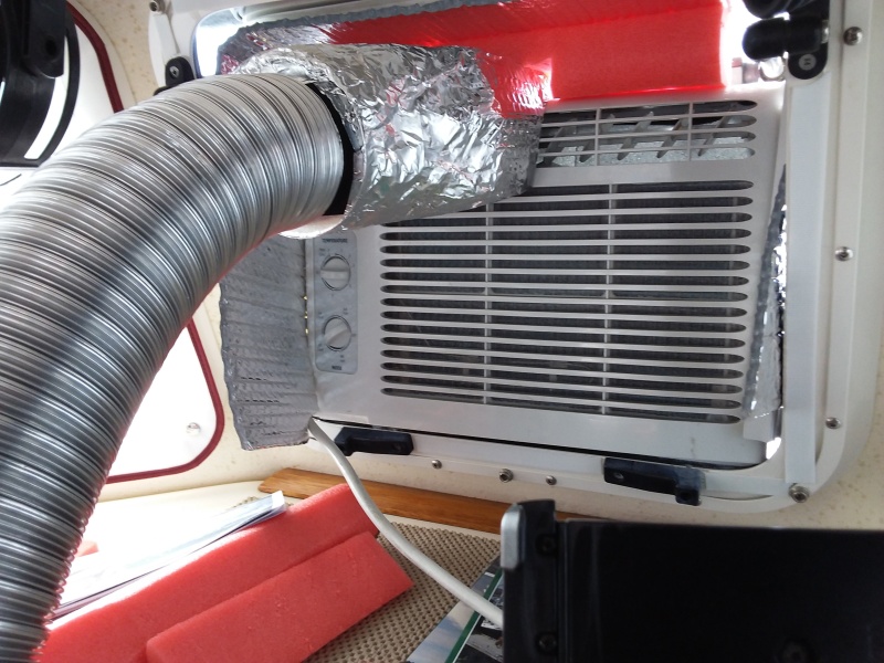 How to cool the v-berth area?  The small Frigidaire AC is place into the center opening window.  I then made a funnel cover that fits over 1 side of the AC.   It literally snaps on using 2 magnets.   Holds fine and I then slide on the hose that runs into the v-berth.   The air blows in quite strong and nicely cools down the forward cabin while the other side of the AC unit is still cooling the main cabin.