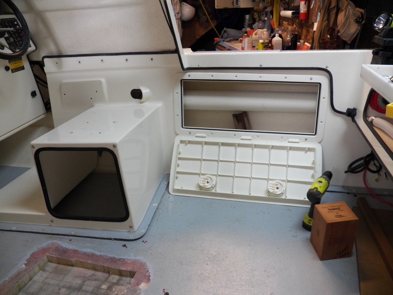 I also put an access hatch on the other side. Once the engine cables (inside the 4" plastic pipe) are moved out of the way, there should actually be some usable space in here.  The new access hatches were installed level with the cockpit deck rather than even with the cockpit trim.  That way when they are opened the entire length of the hatch is supported evenly by the cockpit deck, as shown here.  Protecting the plastic hinges seemed more important than aesthetics.