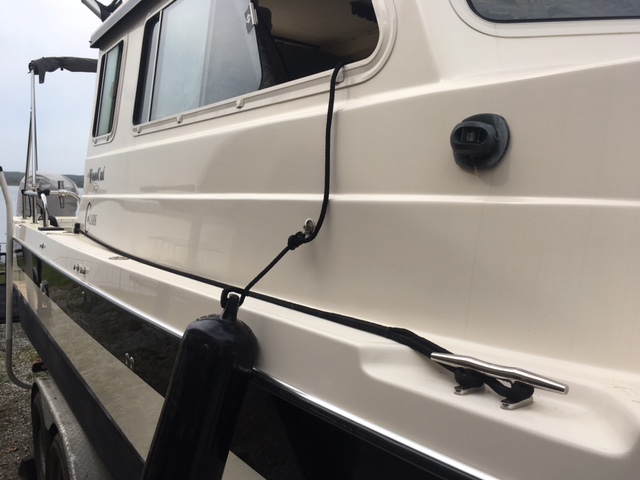 I use a sailboat line lock/cam to secure docking line while underway
