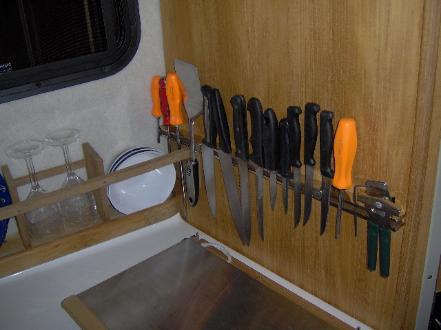 Magnetic bar holds lots of knives and tools