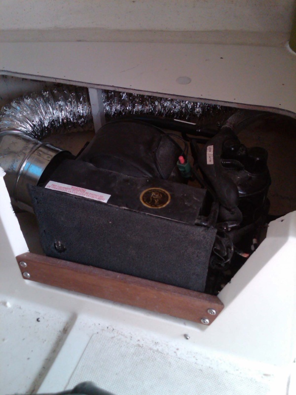 Mermaid AC home w.duct under starboard V-berth.  Had to cut webbing on access hatch to fit.