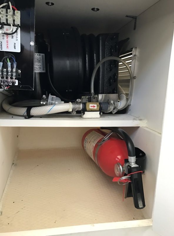 Mermaid air conditioner, fire extinguisher and additional storage in cabinet under passenger seat.