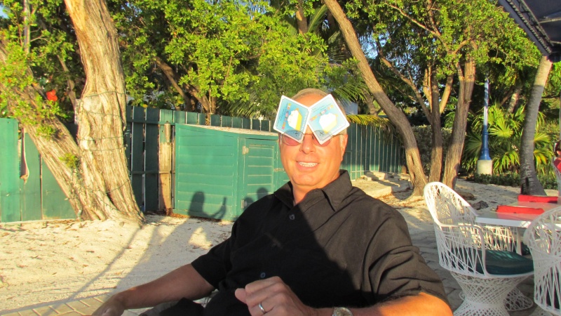 Mike Rizzo playing his cards right to block the bright setting sun in Islamorada at the 
marker 88 restaurant the waiter was particularly slow named Adonnus as I remember. notice the rest of us and Ginny taking the picture in the shadow over Mike's shoulder