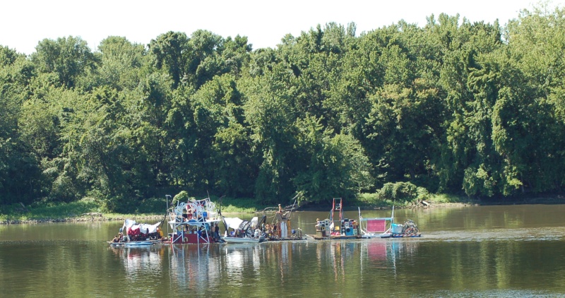 Miss Rockaway (dumpster diver raft, 2 VW diesels, and about 20 hippies), on the way to St. Louis, MO. on Old Man River. It's 80 feet long. Google up "Miss Rockaway" and click on "Blog" for more info.