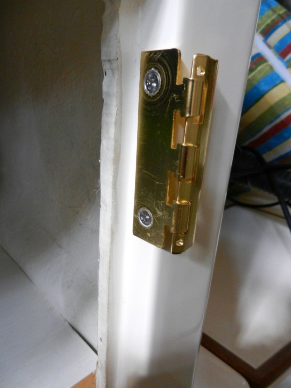 Mounted to cabinet.  There was enough door-edge clearance on all of my cabinets to clear the thickness of the metal.