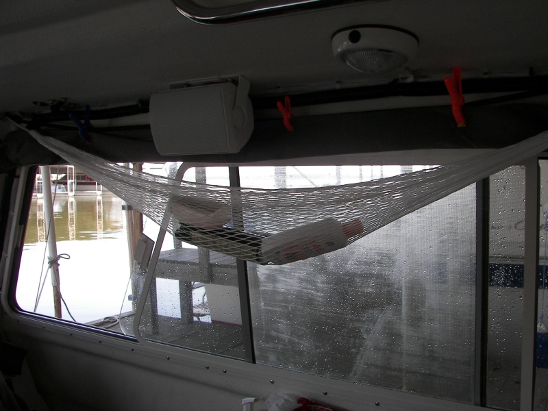My boys don't like the gear hammock, but it keeps things from flying around in rough water and easily comes down. The plastic clips hold the window covers up and corrects that middle sag when down.