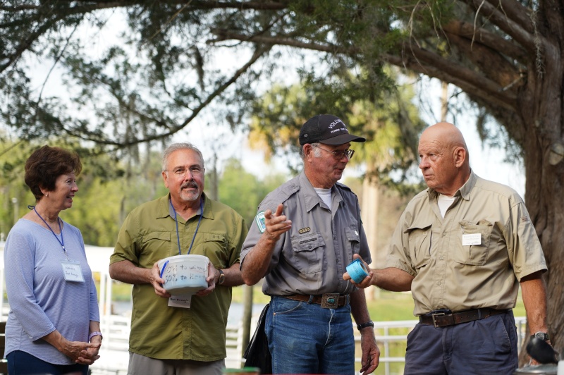 Nancy and John, ticket sellers, Bill (Mystery Girl in his volunteer ranger suit and Tom  explains the 50/50 raffle