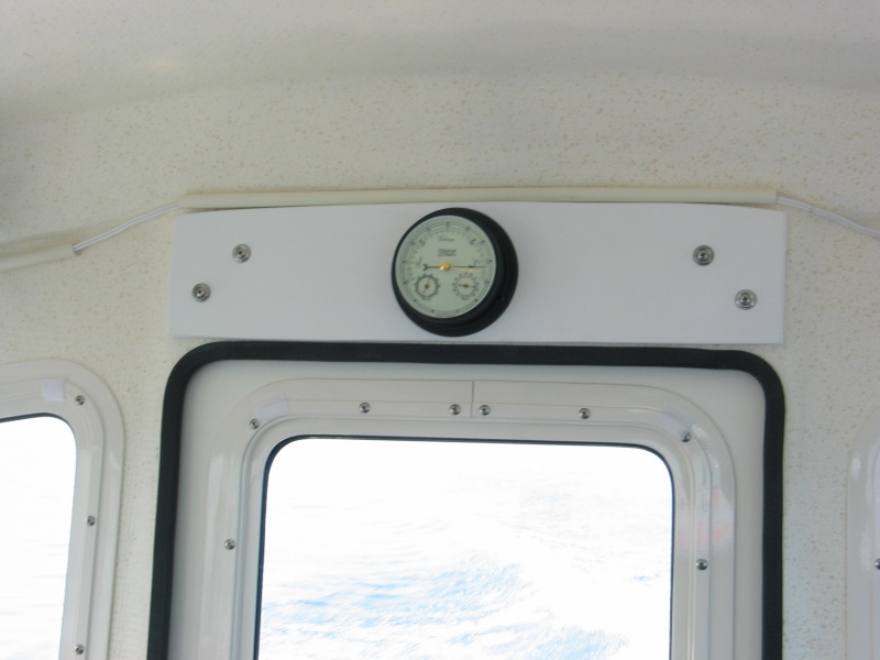 (Not For Hire) Originally wanted barometer on electronics shelf panel next to clock, but wouldn\'t fit. Installed starboard panel over door with longer screws in the factory screw holes and attached barometer with room for future use too.