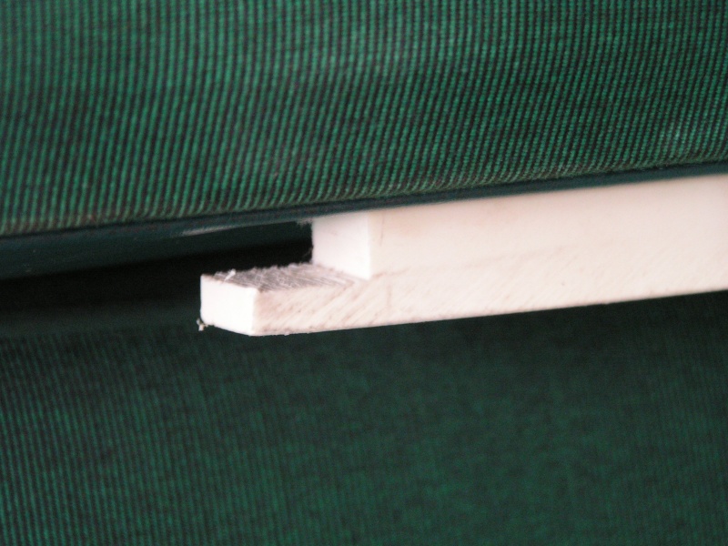 Notch to hook under drywall screw, 1 on each side (front/rear) towards wall end of seat