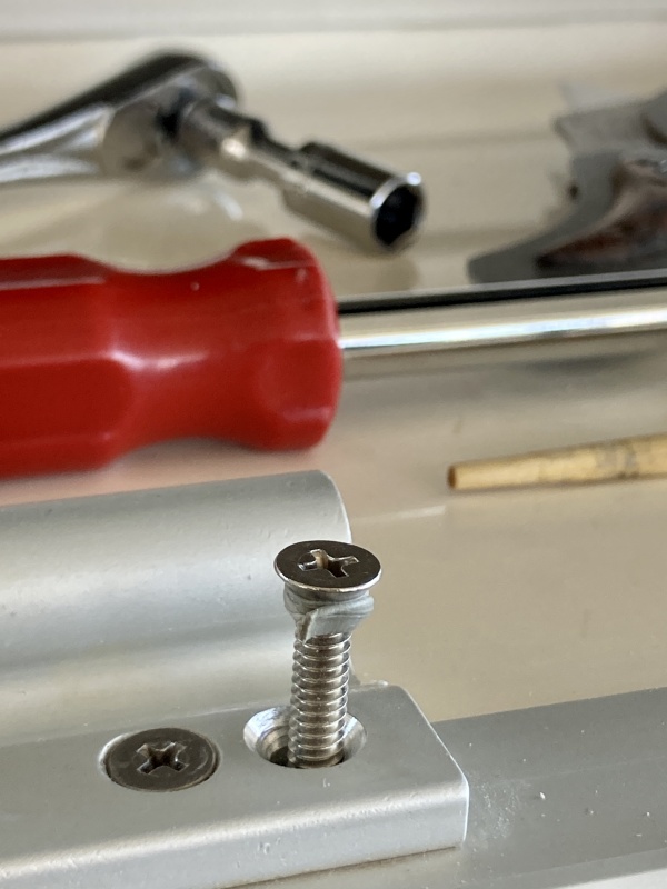 On the left is one of the two machine screws that hold the hinges