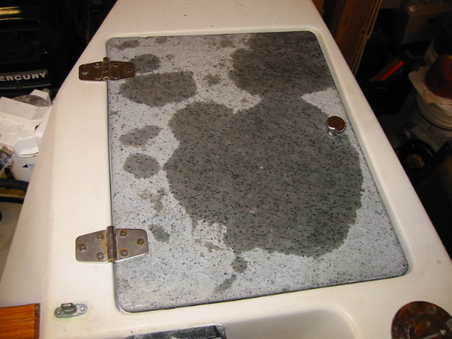 Original cover recessed into molded area -- leaks into lazarette.