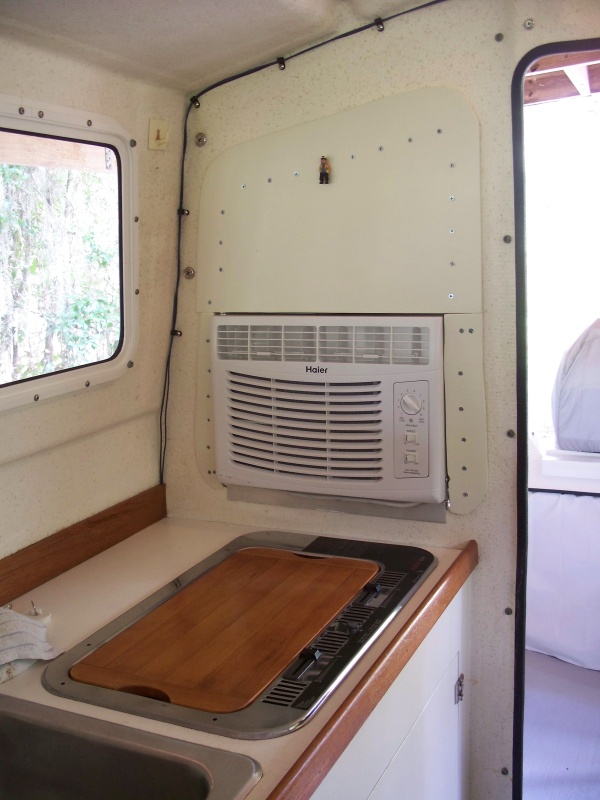 Original window was removed and could be reinstalled at any time. No screw holes were placed in either the enterior or exterior walls; the screws go into a 3/4in plywood panel cut to fit in the window opening not occupied by the AC to hold the interior panel in place. The exterior panel is glued to that 3/4in plywood and thus the interior and exterior panels are pulled together by tightening the screws.