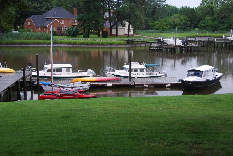 OSPREY\'s dock hosting some of the cruising gang\'s boats. Yes, it was raining.