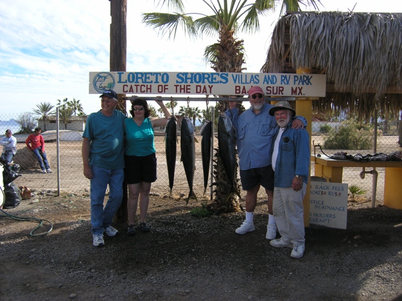 Our group with our yellowtails. The bottomfish are on the cleaning table to the right of us.