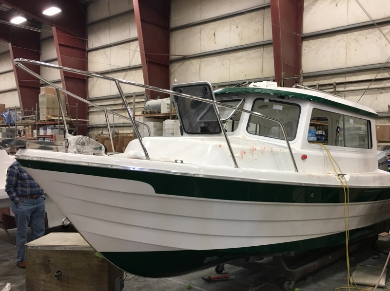 Over in the rigging area, a green stripe Venture 23