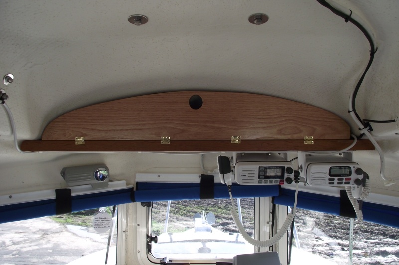 Overhead cabinet door held closed by magnetic catch