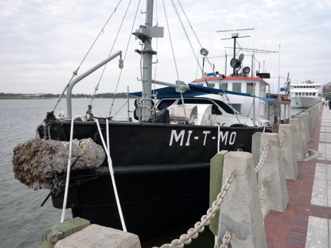 P1000128 Converted ammo carrier. The boat has extensive cruising under it's belt. Uses ramps to get the car on the front deck