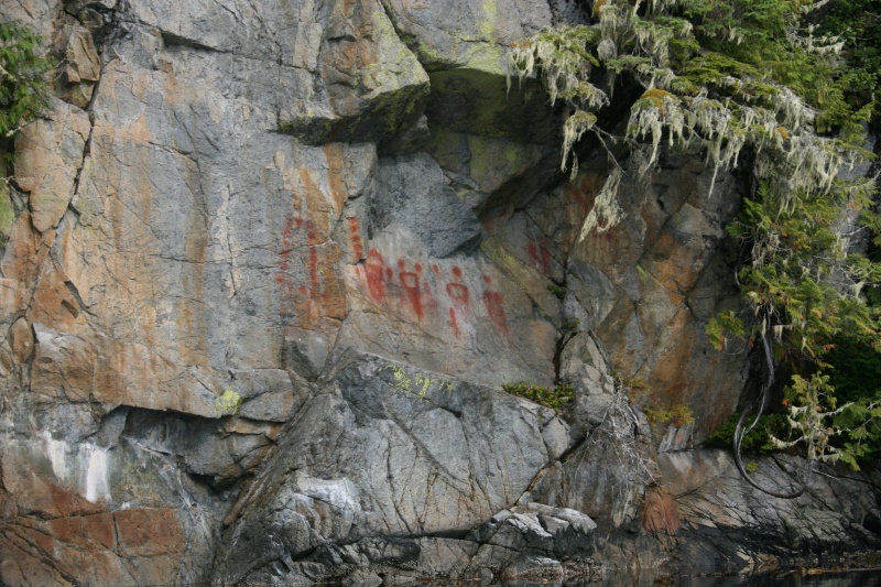 Pictographs in Queen Charlotte Sound. Coppers, moons or suns and a hand and forearm.