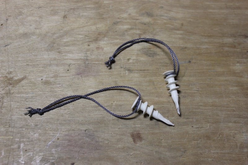 Plugs I used to keep unit in place after installation.  The cords will come in handy to help pull the plugs when I need to get to the anchor rode locker in the future.